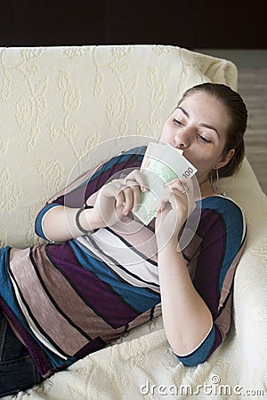 Happy girl kissing euro Stock Photo