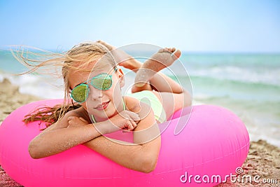 Happy girl lying on inflatable circle Stock Photo