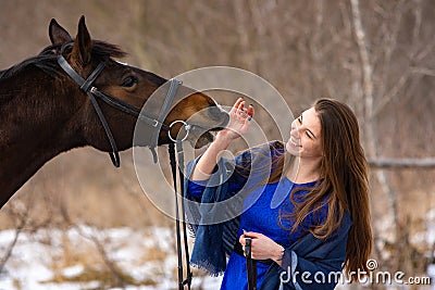 Happy girl playing with horse, horse shows teeth, closeup portrait Stock Photo