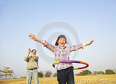 Happy girl playing hula hoops Stock Photo