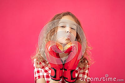 Happy girl with red heart shaped boxing gloves Stock Photo