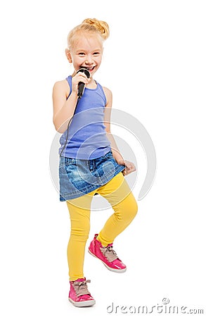 Happy girl singing in microphone and dancing Stock Photo