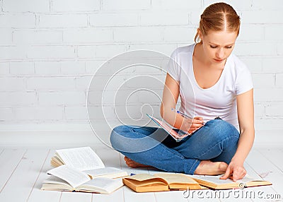 Happy girl student preparing homework, preparing for the exam wi Stock Photo