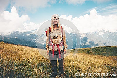 Happy girl Traveler with backpack hiking at mountains Stock Photo