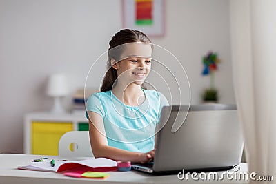 Happy girl typing on laptop at home Stock Photo