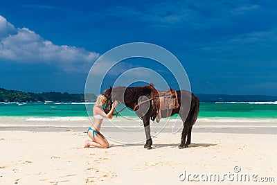 Happy girl walking with horse on a tropical beach Stock Photo