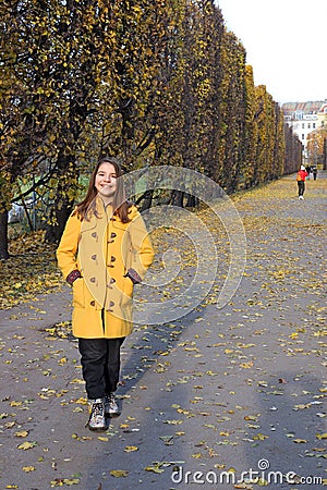 Girl in a yellow coat in the park Augarten Vienna Stock Photo