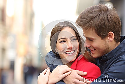 Happy girlfriend with perfect teeth being embraced Stock Photo