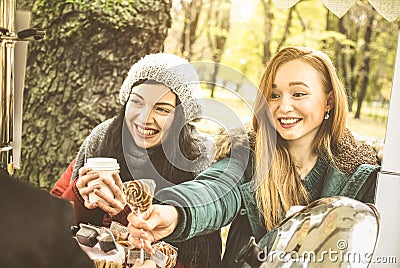 Happy girlfriends best friends sharing time together outdoors with coffee Stock Photo