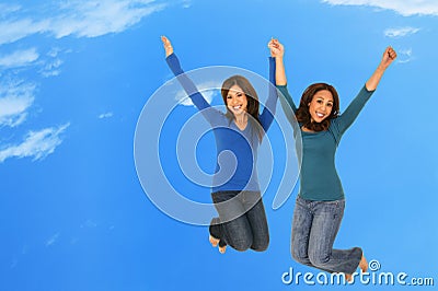 Happy Girls Jumping Over The Cloud Stock Photo