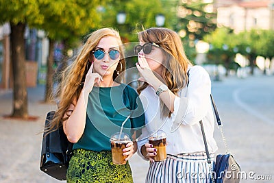 Happy gossip girls walking in the city Stock Photo