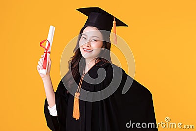 Happy Graduate asian woman in cap and gowm holding Certificated Stock Photo