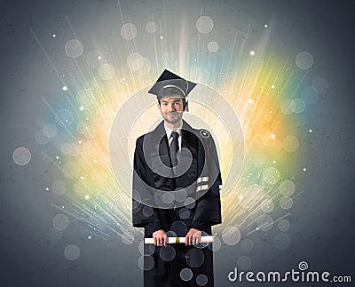 Happy graduate with colorful bokeg lights in the background Stock Photo