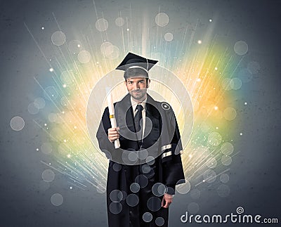 Happy graduate with colorful bokeg lights in the background Stock Photo