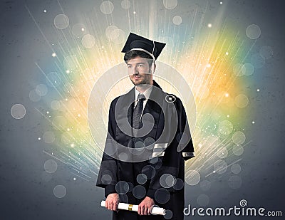 Happy graduate with colorful bokeg lights in the background Stock Photo