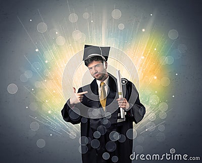 Happy graduate with colorful bokeg lights in the background Stock Photo