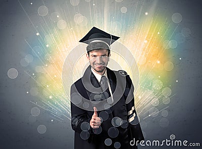 Happy graduate with colorful bokeg lights in the background Stock Photo