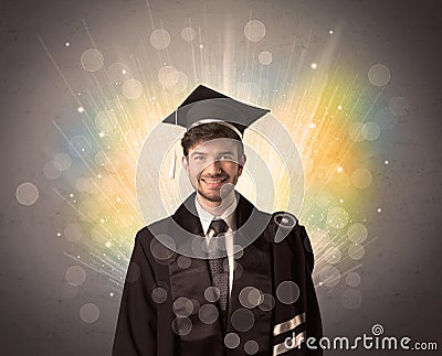 Happy graduate with colorful bokeg lights in the background Stock Photo