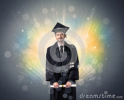 Happy graduate with colorful bokeg lights in the background Stock Photo