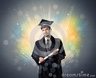 Happy graduate with colorful bokeg lights in the background Stock Photo