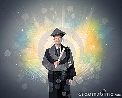 Happy graduate with colorful bokeg lights in the background Stock Photo