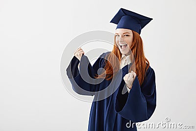 Happy graduate girl in mantle rejoicing laughing smiling over white background. Stock Photo