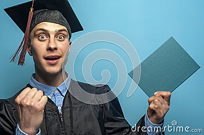 Happy Graduate man holding up a diploma Stock Photo