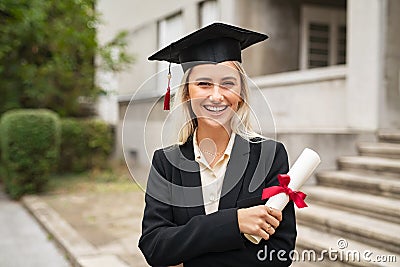 Happy graduate student wearing graduation cap Stock Photo