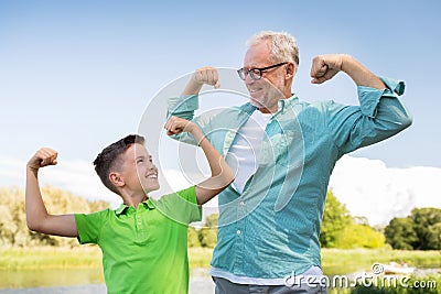 Happy grandfather and grandson showing muscles Stock Photo