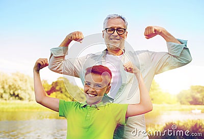 Happy grandfather and grandson showing muscles Stock Photo