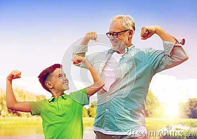 Happy grandfather and grandson showing muscles Stock Photo