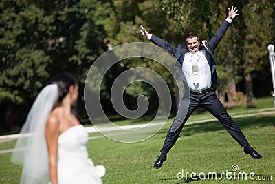 Happy groom in jump Stock Photo