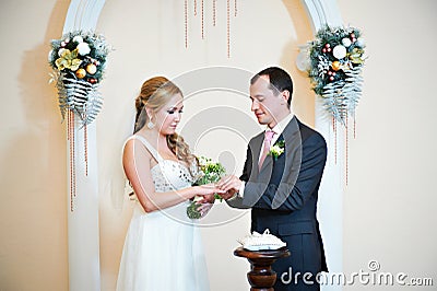 Happy groom wears wedding ring his bride Stock Photo