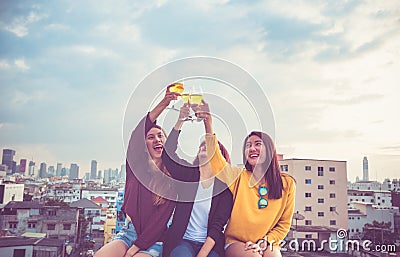 Happy group of asia girl friends enjoy laughing and cheerful toast sparkling wine glass at rooftop party,Holiday celebration fest Stock Photo