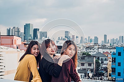 Happy group of asia girl friends enjoy relax pose at roof top pa Stock Photo