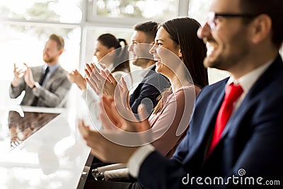 Happy group of businesspeople clapping in office Stock Photo