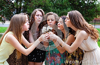 happy group female friends with bouquet of dandelions in the park Stock Photo