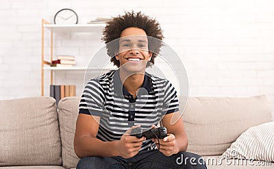 Happy guy enjoying computer game, playing with joystick Stock Photo