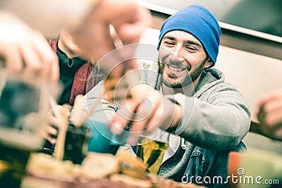 Happy guy with friends eating finger food and drinking beer Stock Photo