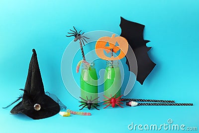 Happy Halloween, bottles with green cocktail, witch hat, mystical decor on a bright background Stock Photo