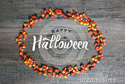 Happy Halloween Calligraphy With Candy Corn Oval Border Over Rustic Wooden Background, Horizontal Stock Photo