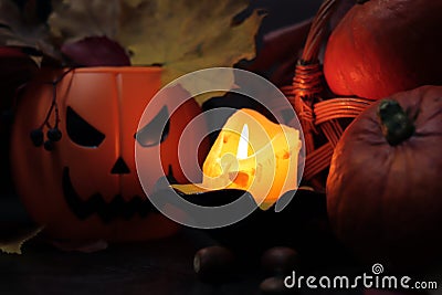 Happy Halloween. A candle illuminates a composition for Halloween Stock Photo