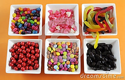 Happy Halloween candy in square white bowls Stock Photo