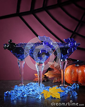 Happy Halloween ghoulish party cocktail drinks with blue martini glasses Stock Photo