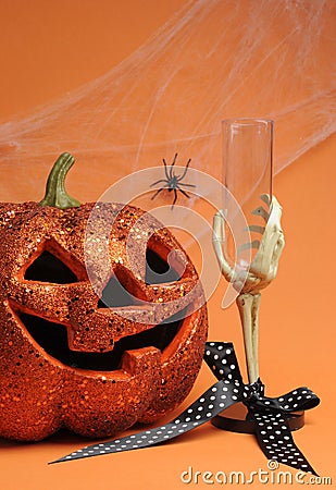 Happy Halloween Jack-o-lantern pumpkin with skeleton hand glass - vertical with copy space for your text here. Stock Photo