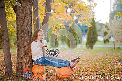 Happy Halloween! Little girl carving pumpkin at Halloween. Dressed up children trick or treating. Kids trick or treat. Toddler kid Stock Photo