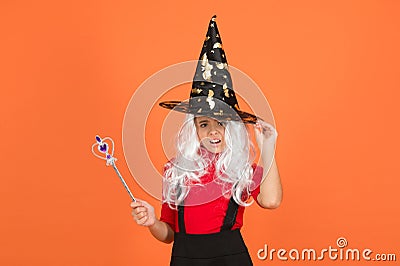 Happy halloween. smiling child in witch hat. kid hold magic wand. childhood happiness. teen girl ready to celebrate Stock Photo