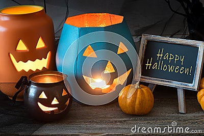 Happy Halloween Still Life Card with Message Words and Pumpkins in Orange, Black and Turquoise. Horizontal with front view Stock Photo