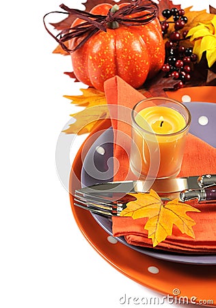 Happy Halloween or Thanksgiving party table place setting with orange and purple theme - vertical. Stock Photo