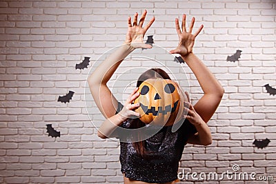 Happy Halloween! Two young cute women with pumpkin head frighten Stock Photo